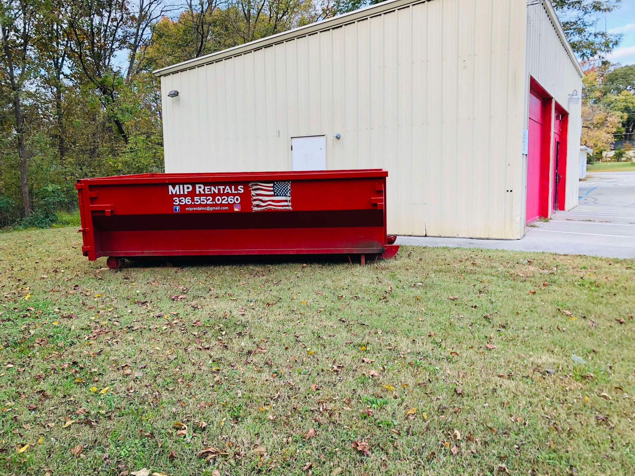 a dumspter in the side of garage Dumpster Rental