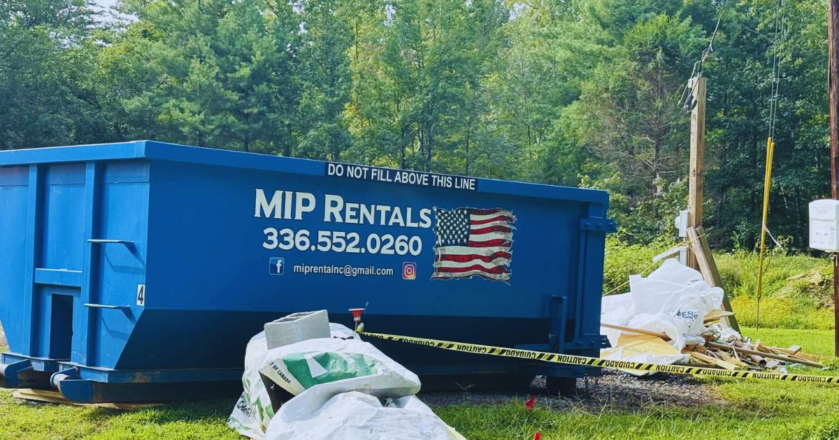 Blue dumpster labeled with 'MIP Rentals' and cautionary message 'DO NOT FILL ABOVE THIS LINE.' The image emphasizes proper waste disposal practices and highlights the risks associated with overloading the dumpster. The scene features a clean and orderly setup with a caution tape surrounding the area.