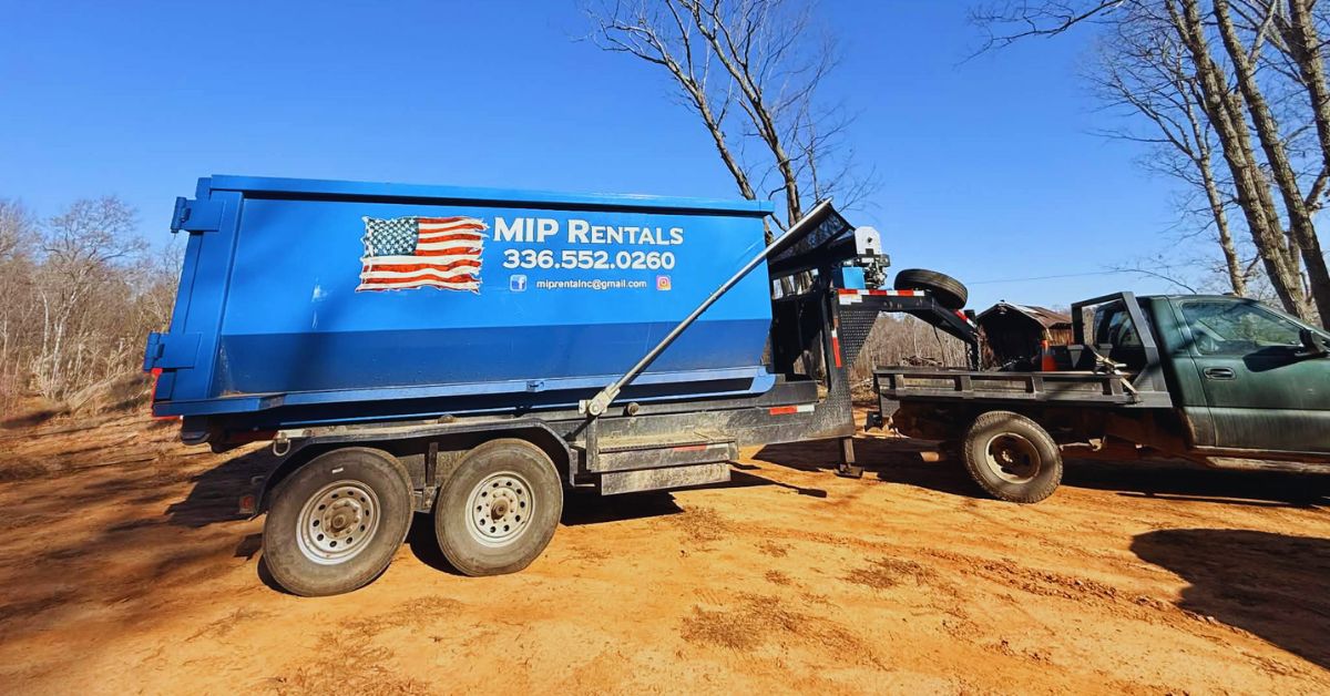 Dumpster rental truck delivering a 20-yard roll-off dumpster, the right size for your project in North Carolina