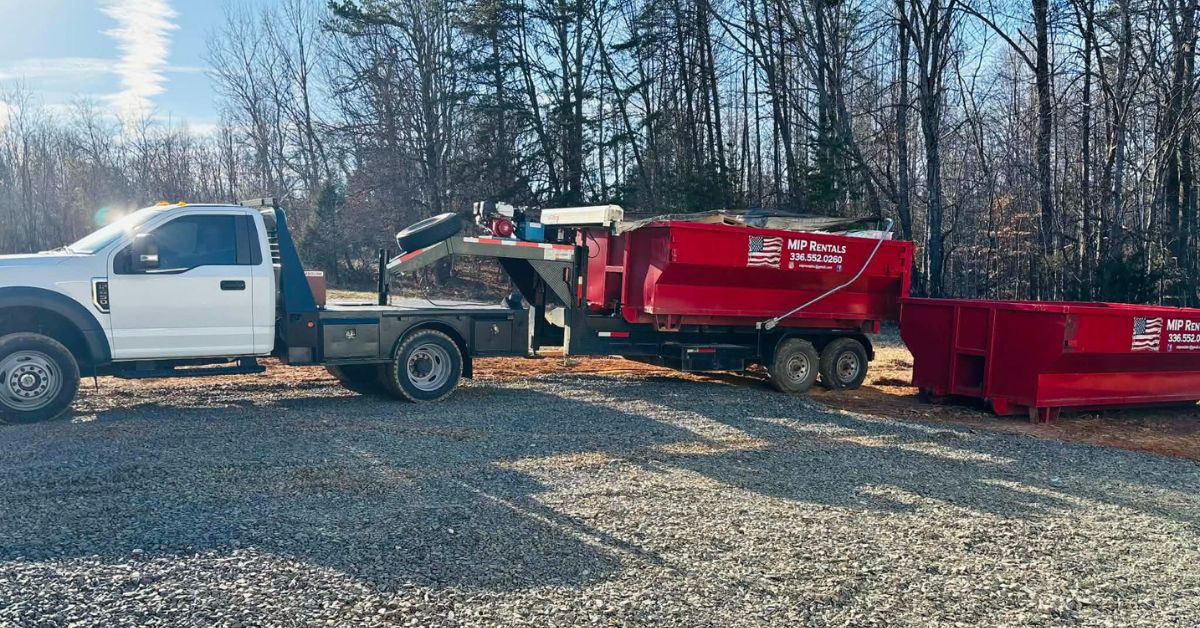 Fast and Affordable Dumpster Rentals in North Carolina with roll-off dumpster delivery in the Triad, showing a red dumpster being loaded for home and construction cleanup