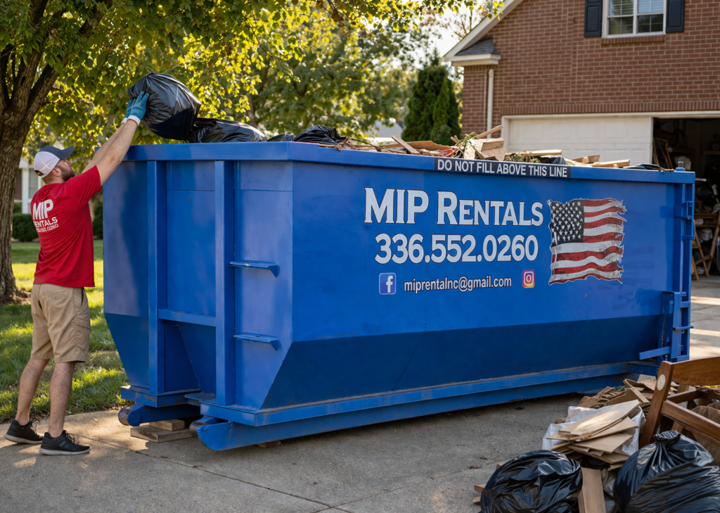Easiest Way to Handle Waste Across Stokesdale with a large 20-yard MIP Rentals dumpster as a worker in a red shirt loads trash during a home cleanup